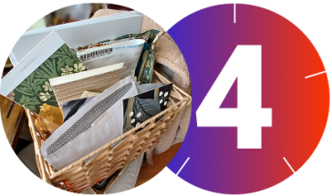 A circular split-image graphic: the right half features a large white number "4" on a red-to-purple gradient background with subtle clock-like tick marks; the left half shows a wicker basket filled with decorative papers and samples, including floral patterns, textured swatches, and envelopes, resting on a cushioned chair.